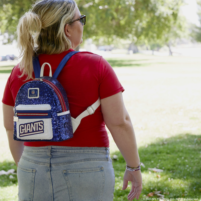 Image of woman facing away from camera wearing the NFL New York Giants Sequin Mini Backpack 